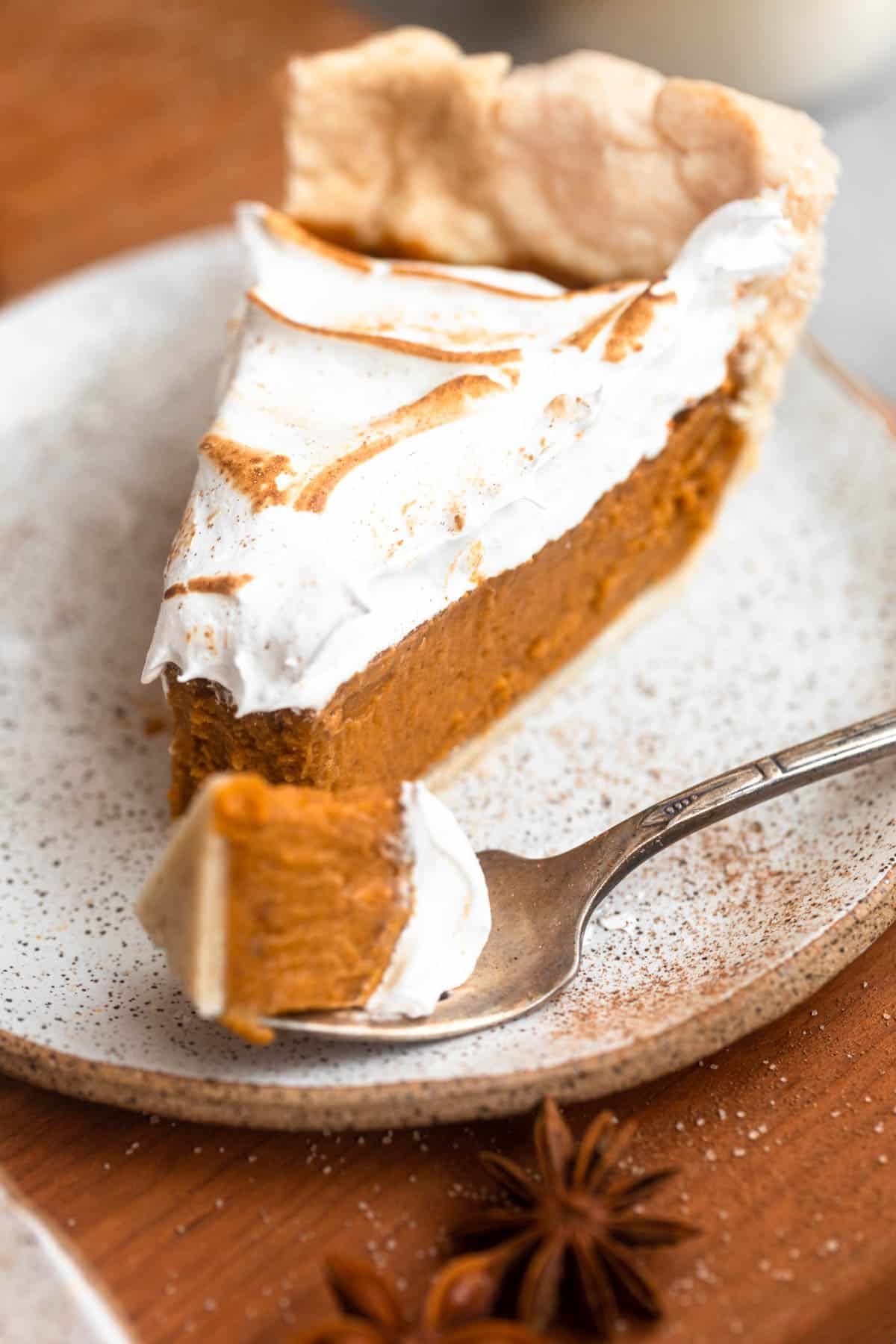 gluten free sweet potato pie on a plate with a fork taking a bite