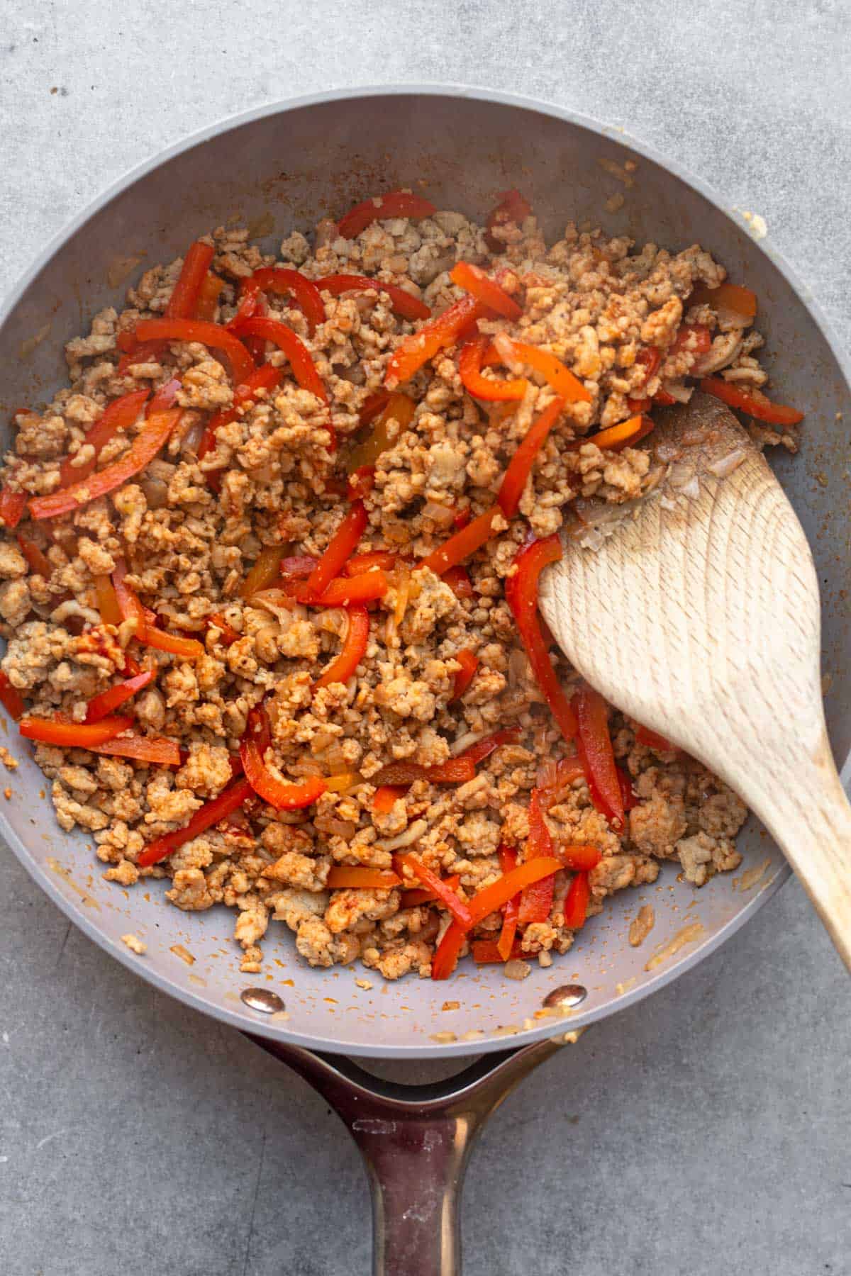meat and veggies cooking in a pan
