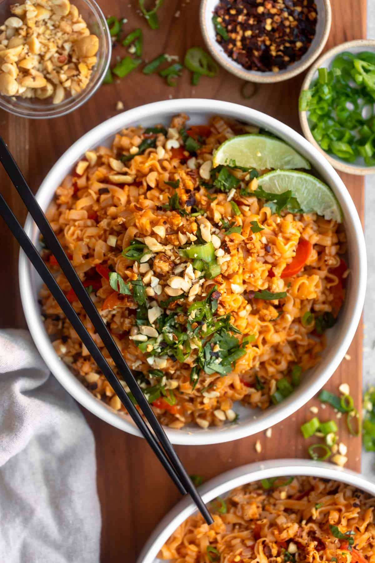 chicken curry noodles in a bowl with chopsticks on the side