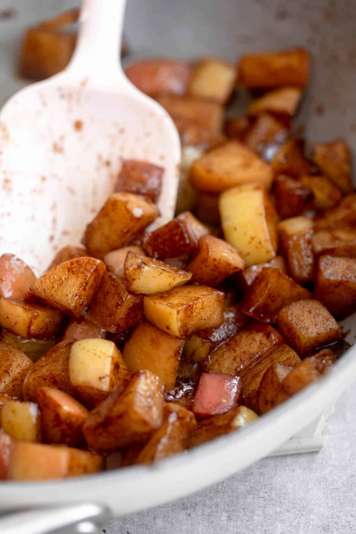 angled view of the apples in a pan after cooking