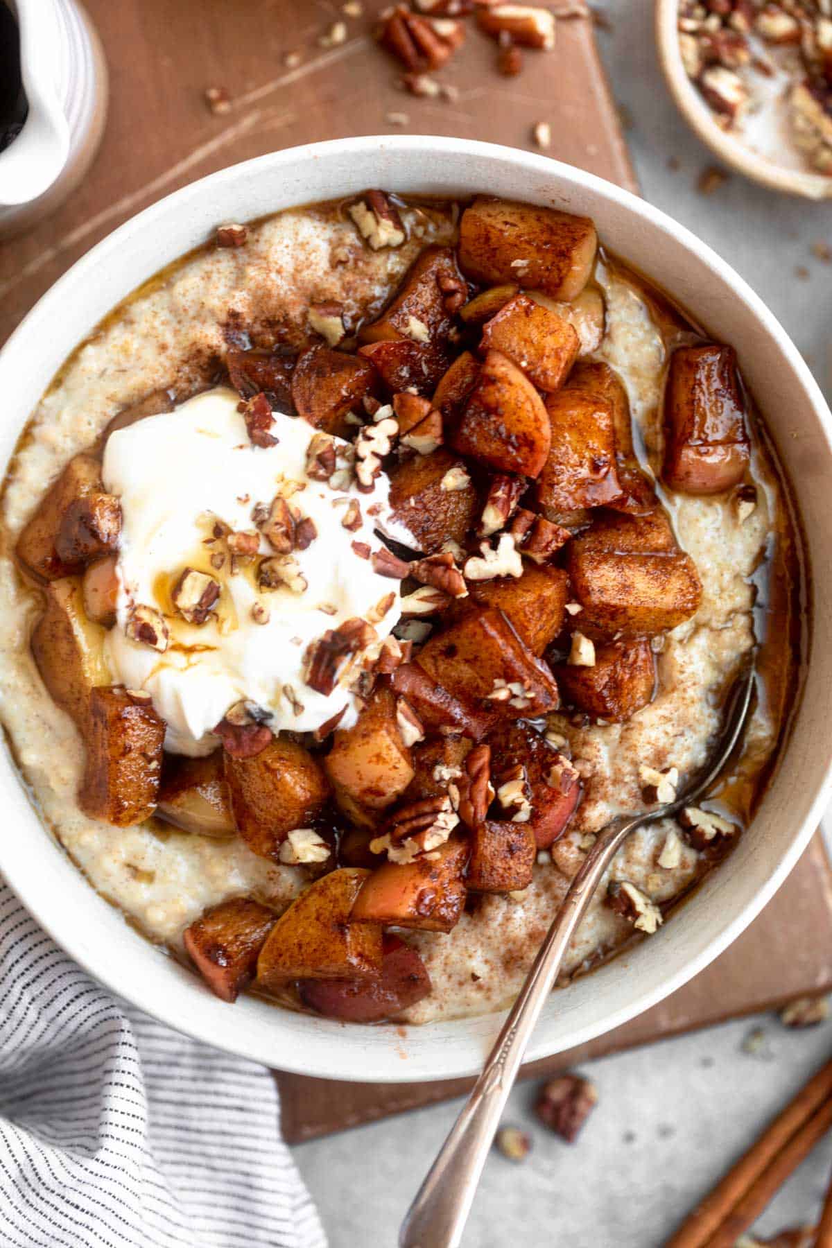 gluten free oatmeal in a bowl with sauteed maple apples on top 