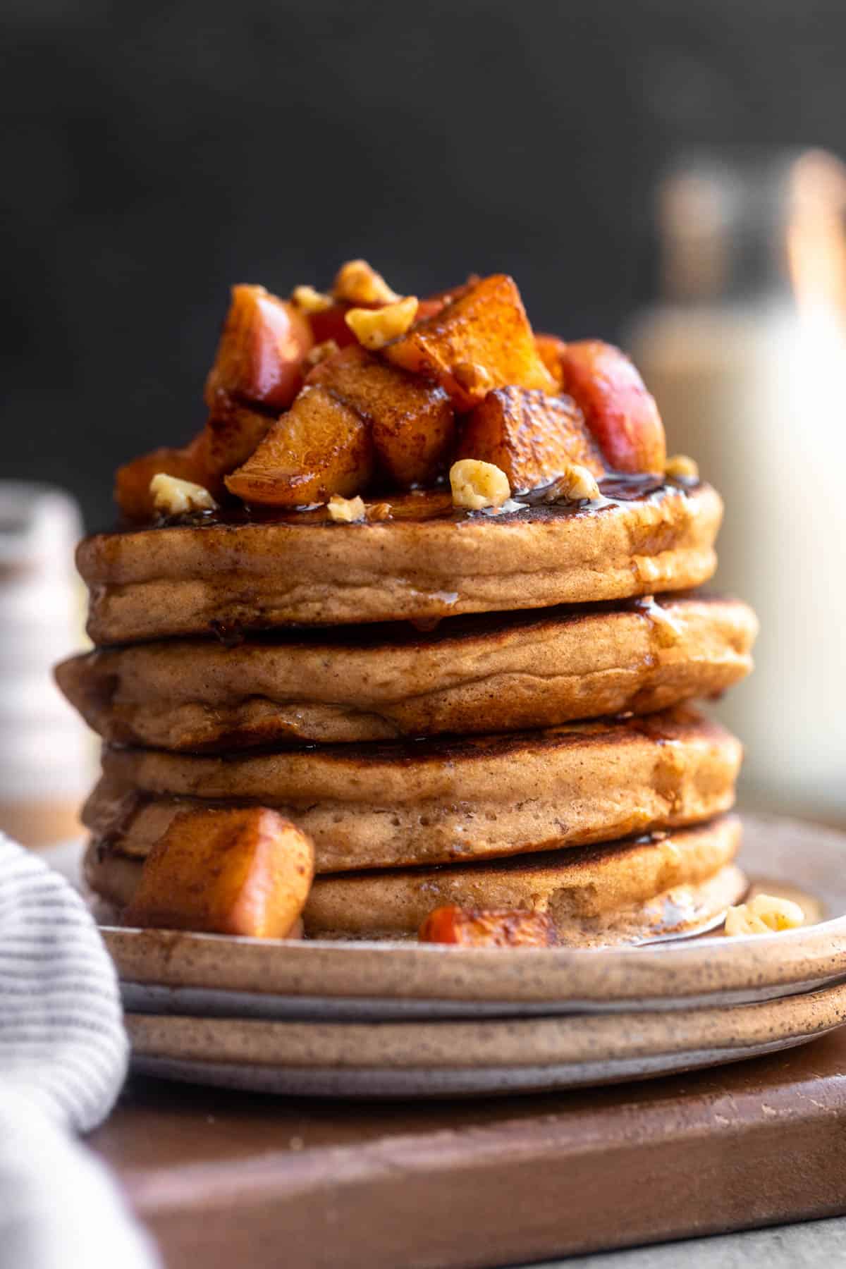 stack of gluten free apple pancakes on a plate with maple syrup