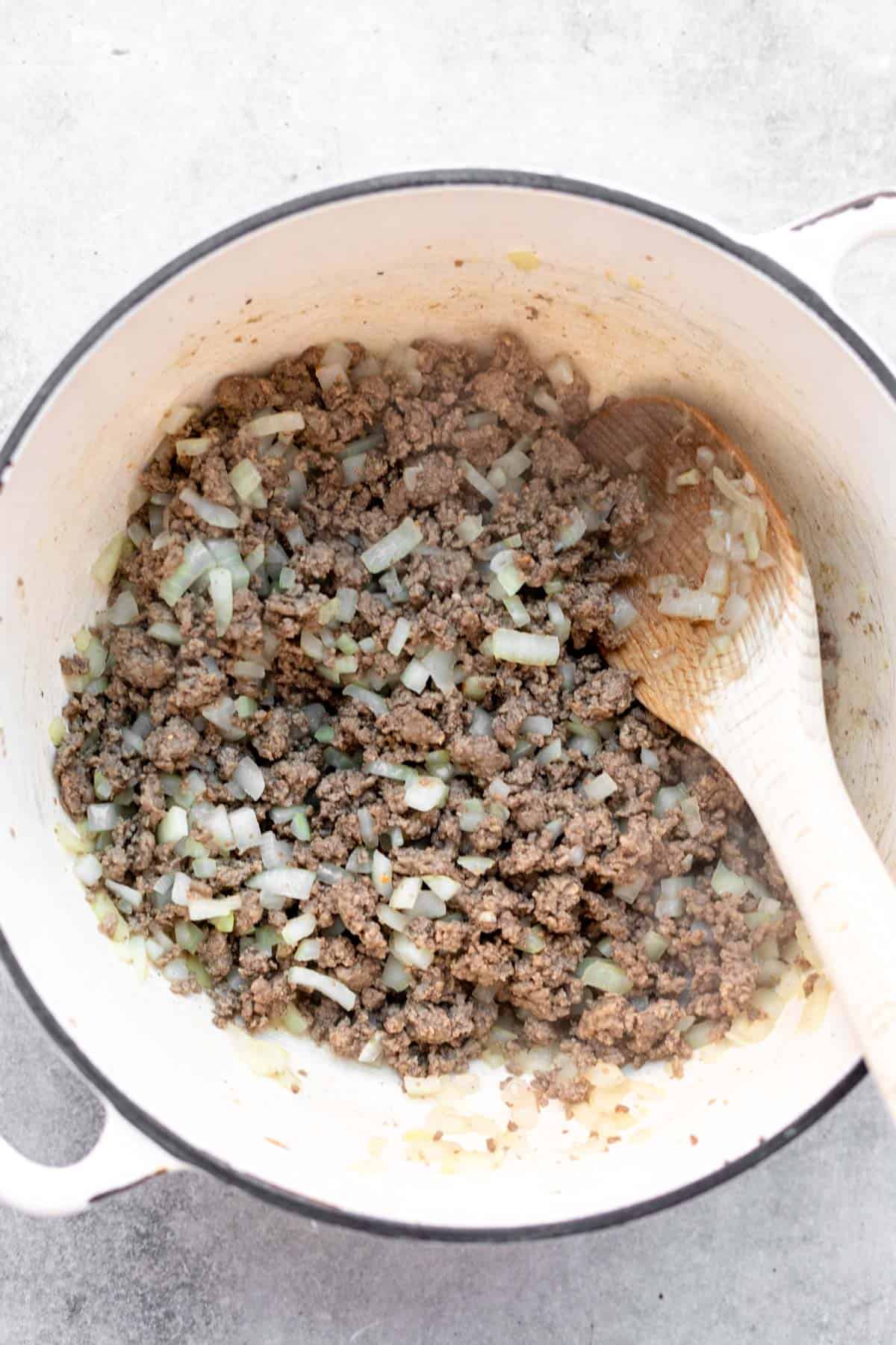sauteeing the beef in a pot