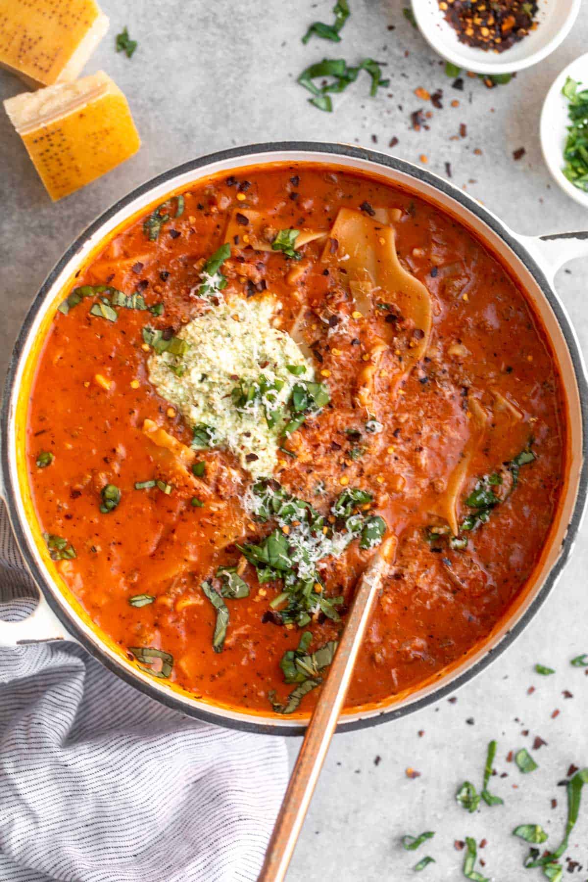 gluten free lasagna soup in a pot with a spoon on the side