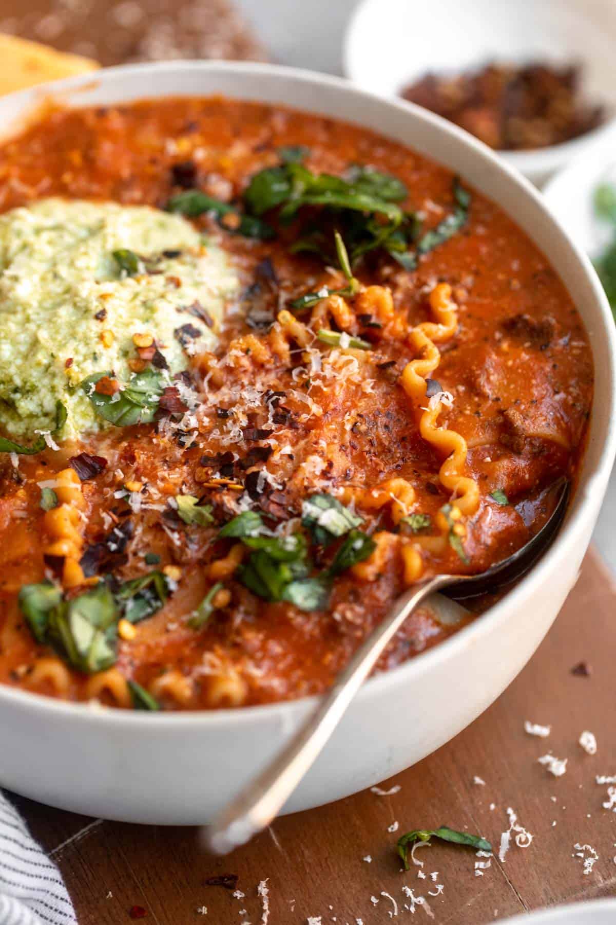 angled view of gluten free lasagna soup in a bowl with basil