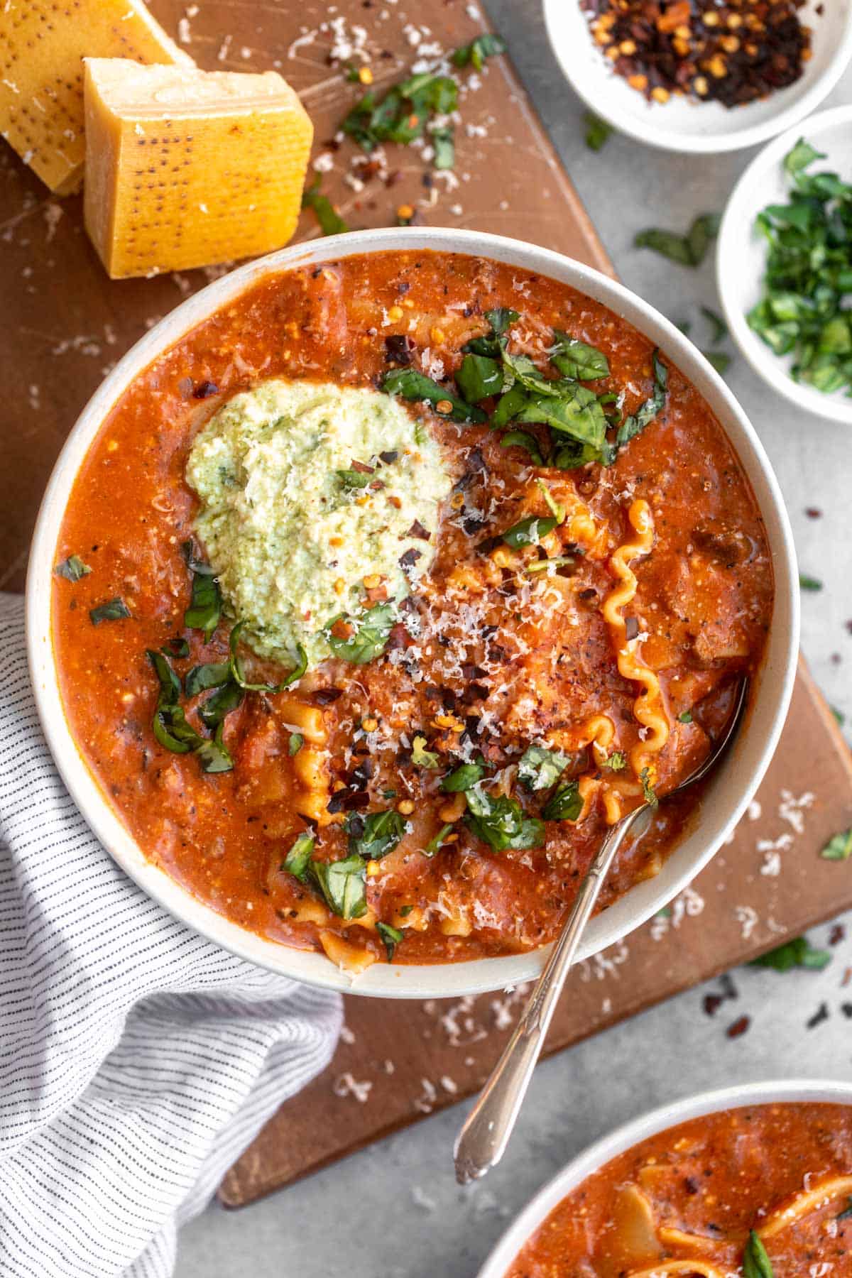 gluten free lasagna soup in a bowl with a spoon on the side