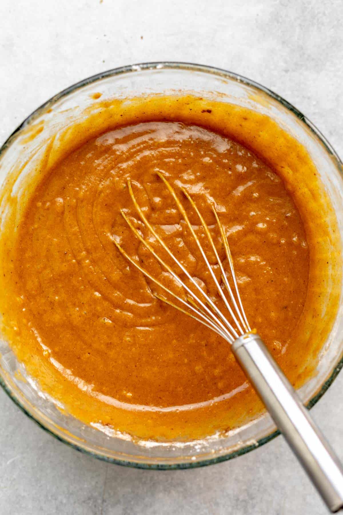 batter in a mixing bowl with a whisk