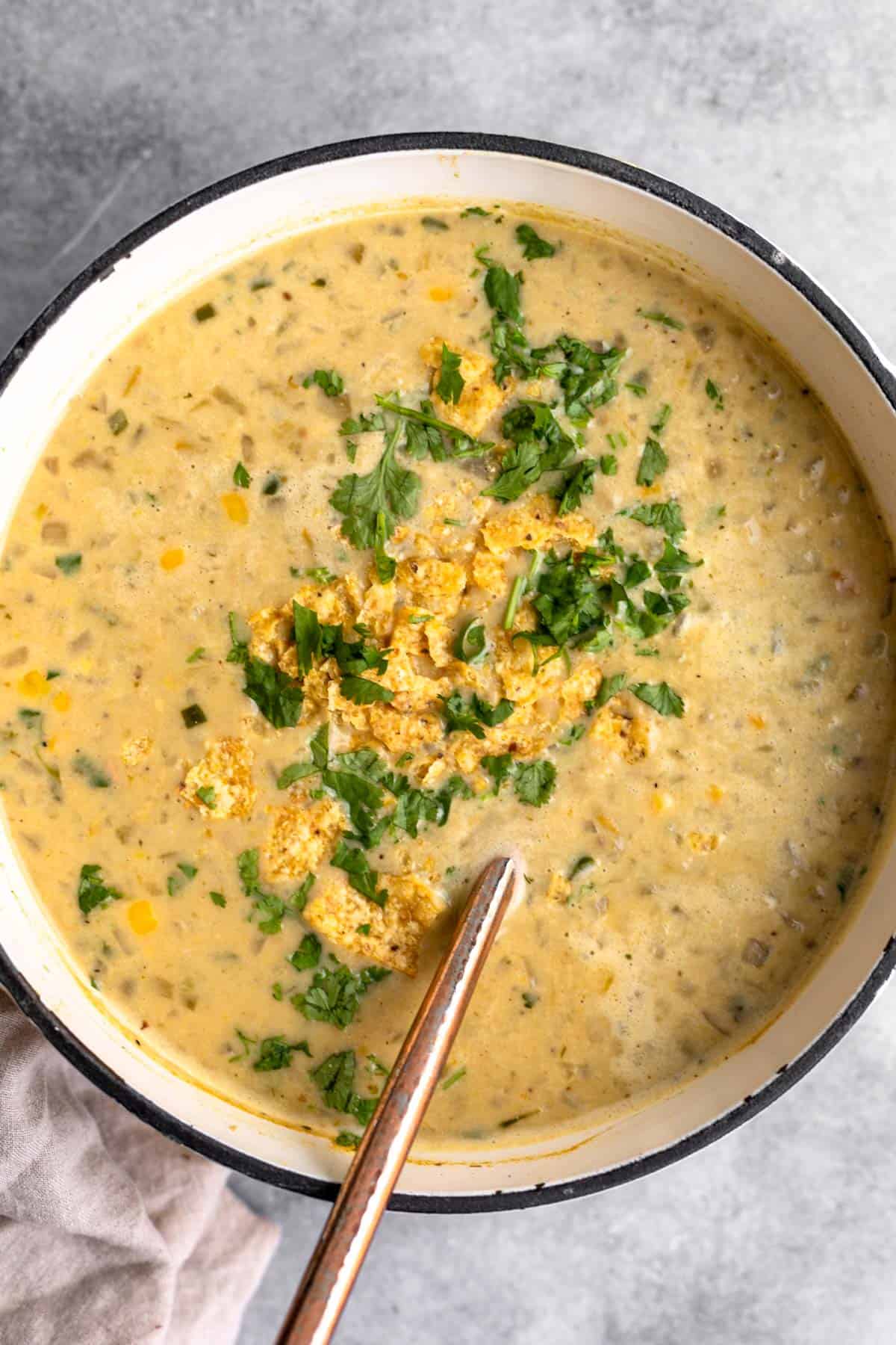 vegan white bean chili in a pot with chips on top